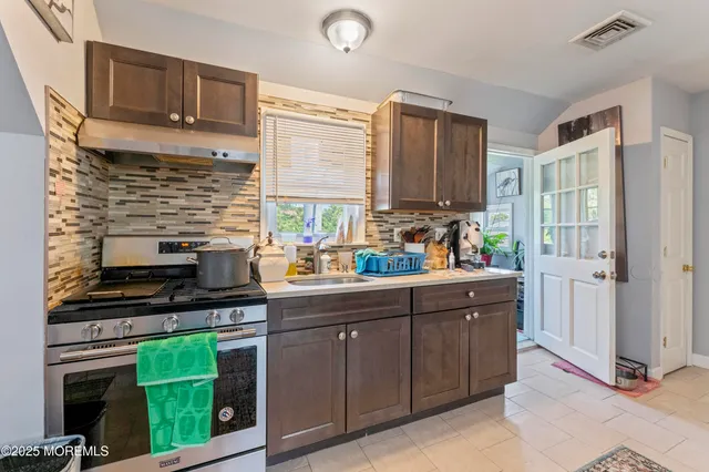 a kitchen with a sink cabinets and window