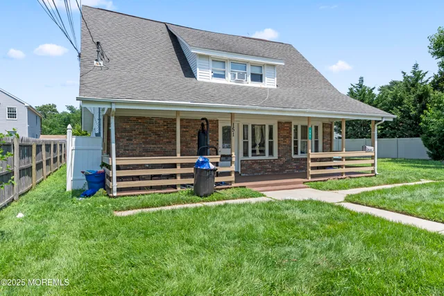 a view of a house with a yard and a park