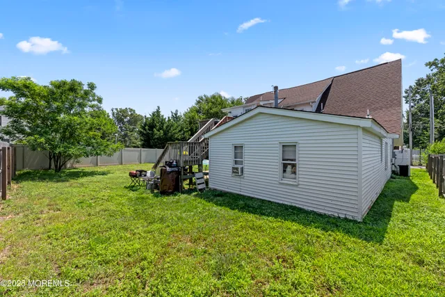 a backyard of a house with plants and tree