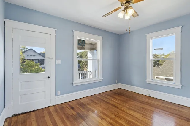wooden floor in an empty room with a window