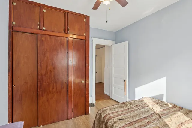 a bedroom with a bed and a chandelier