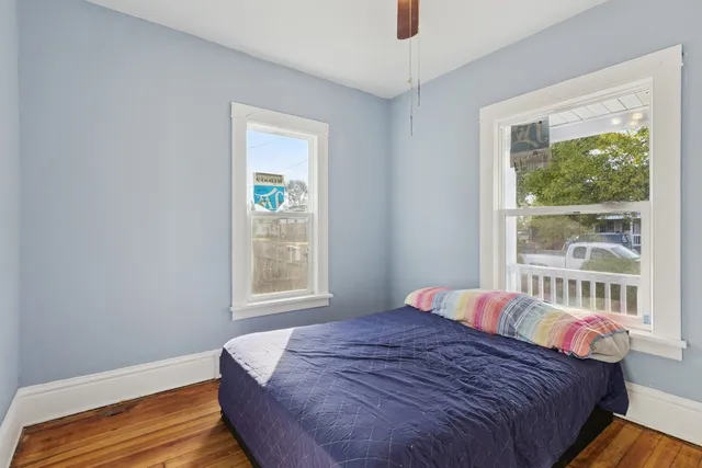 a view of a room with wooden floor and windows
