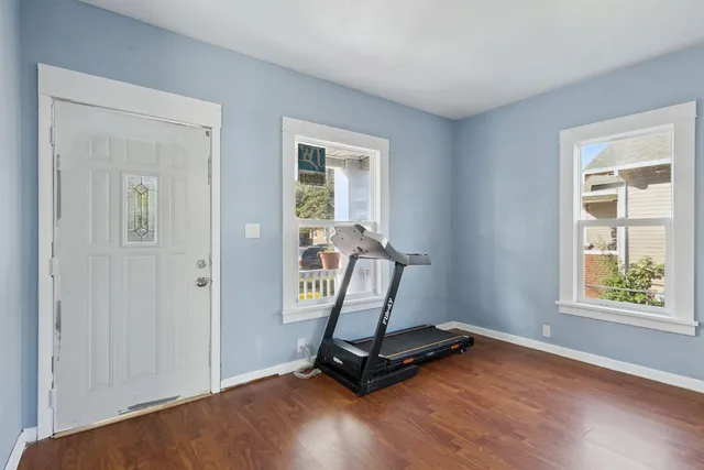 a view of room with window and wooden floor
