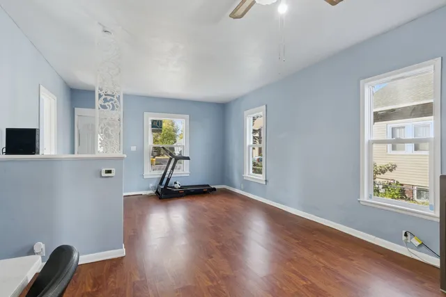 a kitchen with granite countertop white cabinets and a sink
