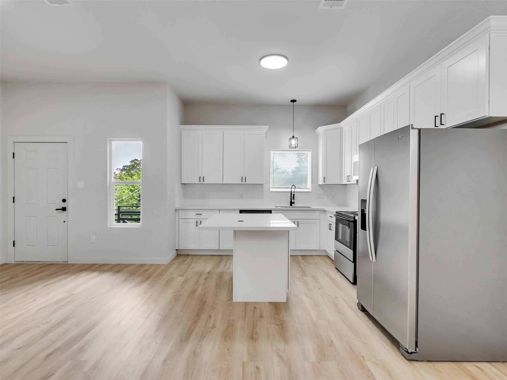 9709 Cargill Street, Unit AB Houston, TX 77029 - Photo 13 of 32 a kitchen with a refrigerator and a stove top oven