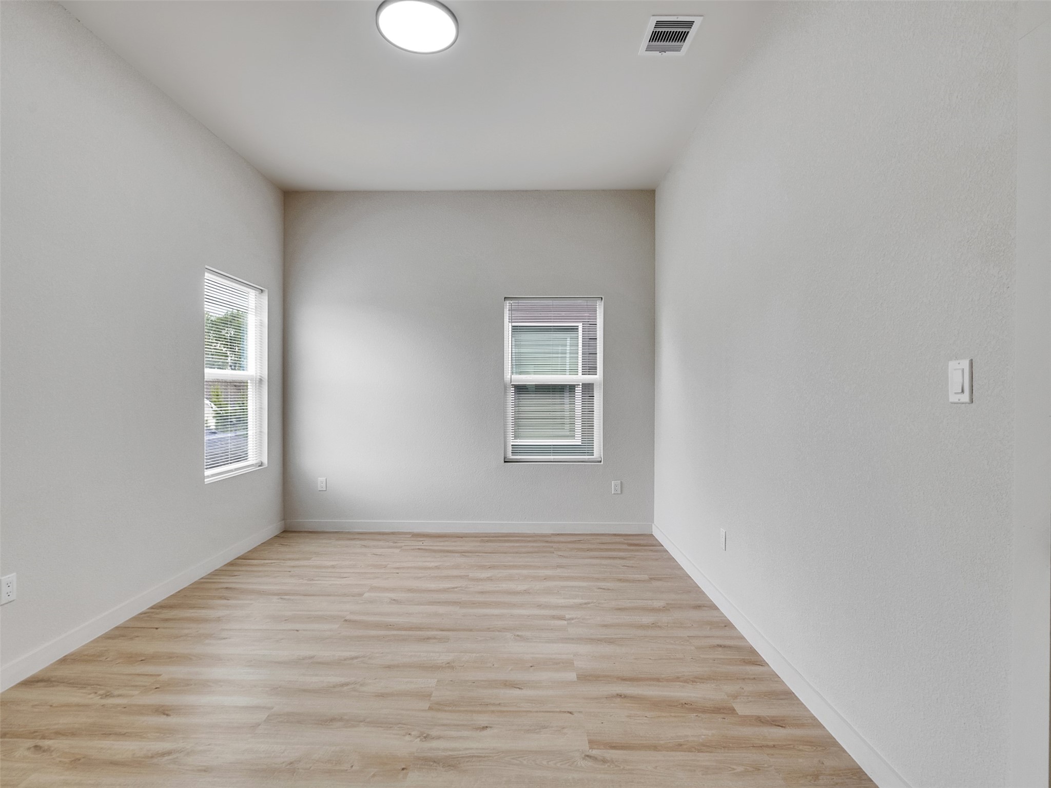 9709 Cargill Street, Unit AB Houston, TX 77029 - Photo 25 of 32 a view of an empty room with wooden floor and a window