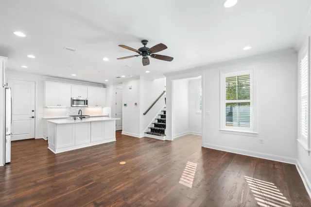 a view of kitchen with sink microwave and cabinets