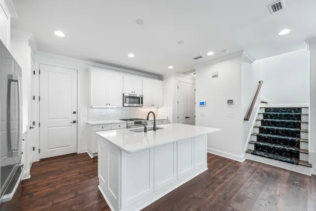 a kitchen with sink refrigerator and stove