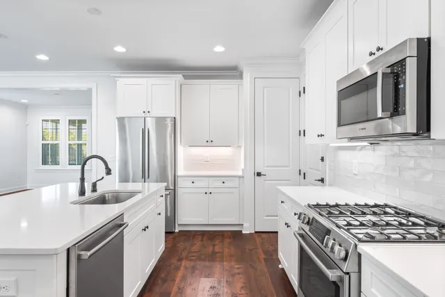 a kitchen with a sink stove and refrigerator