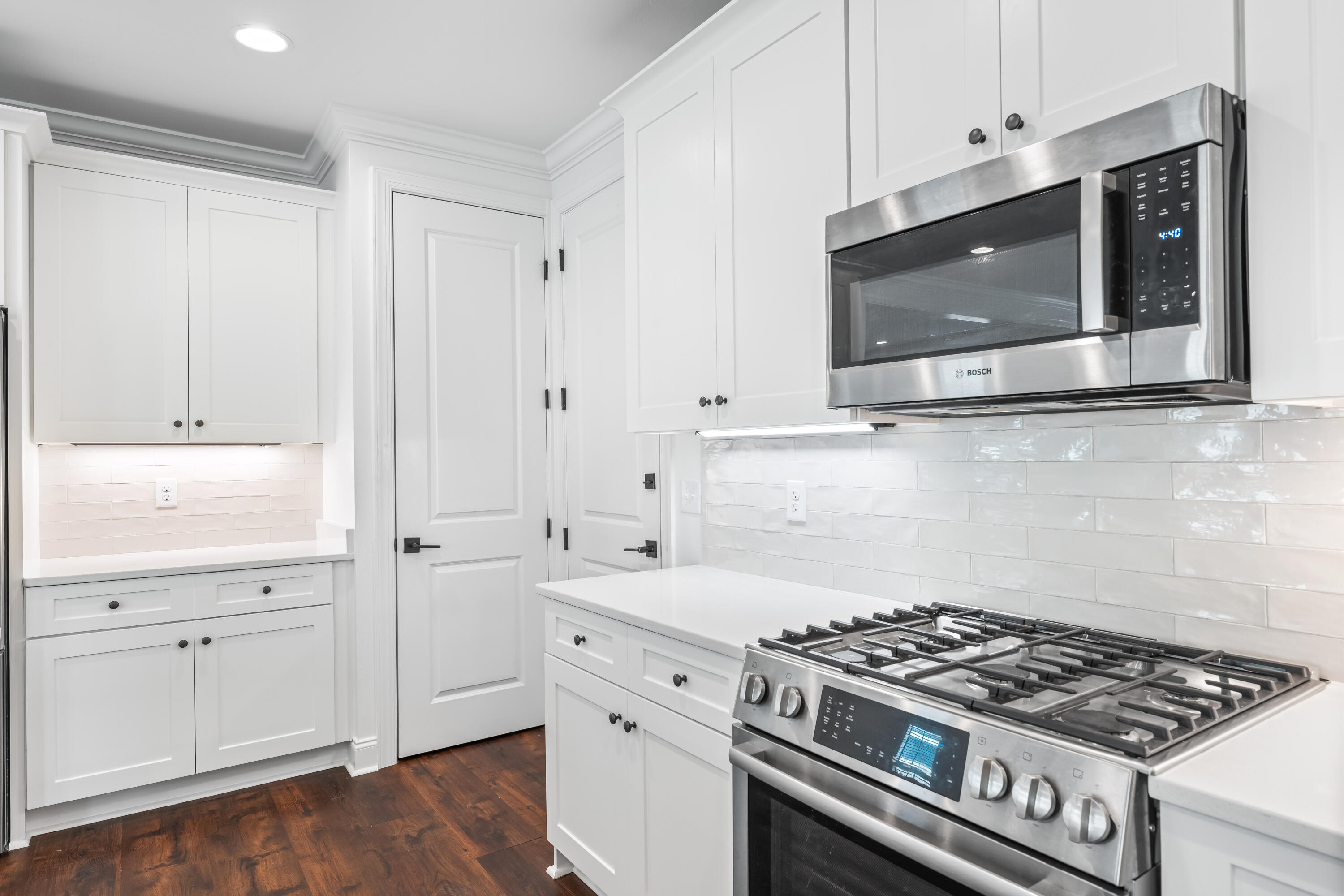 253 Windrow Way Watersound, FL 32461 - Photo 20 of 46 a kitchen with stainless steel appliances white cabinets and a stove a oven with white countertops