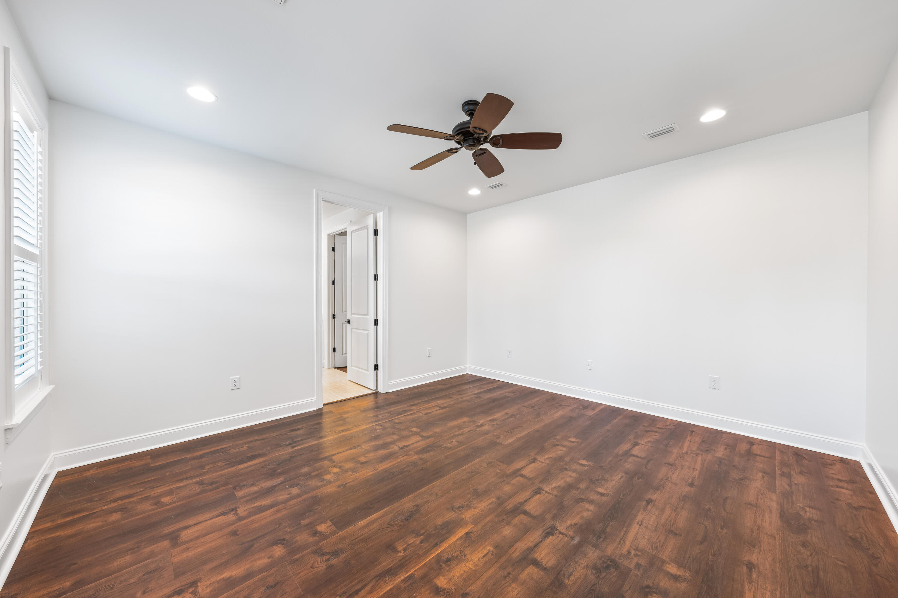 253 Windrow Way Watersound, FL 32461 - Photo 25 of 46 an empty room with wooden floor and windows