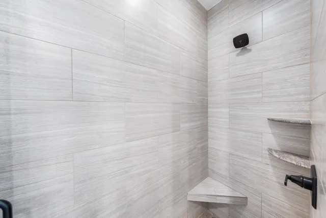 a bathroom with a tub sink and mirror