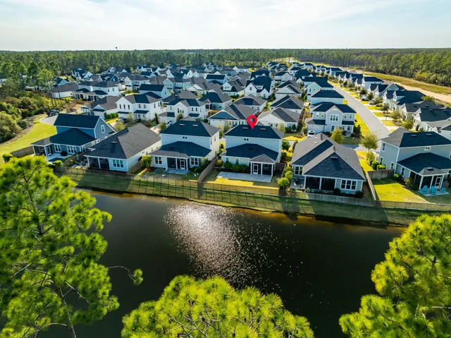 an aerial view of a house with a lake view