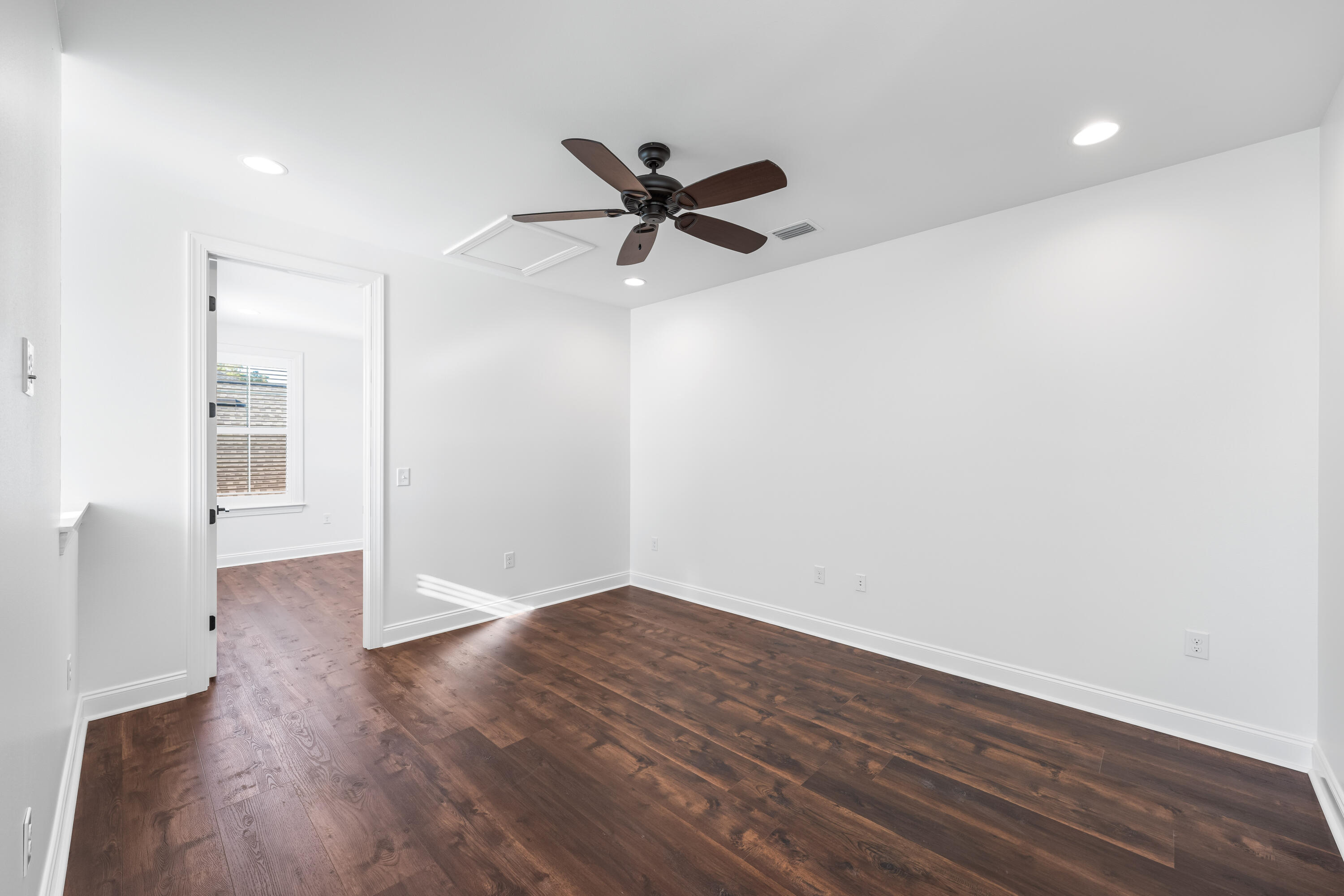 253 Windrow Way Watersound, FL 32461 - Photo 32 of 46 an empty room with wooden floor a ceiling fan and windows
