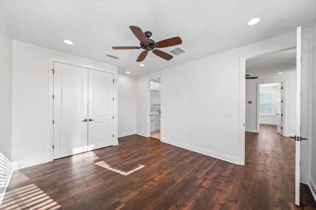 a bathroom with a double vanity sink a mirror and a toilet