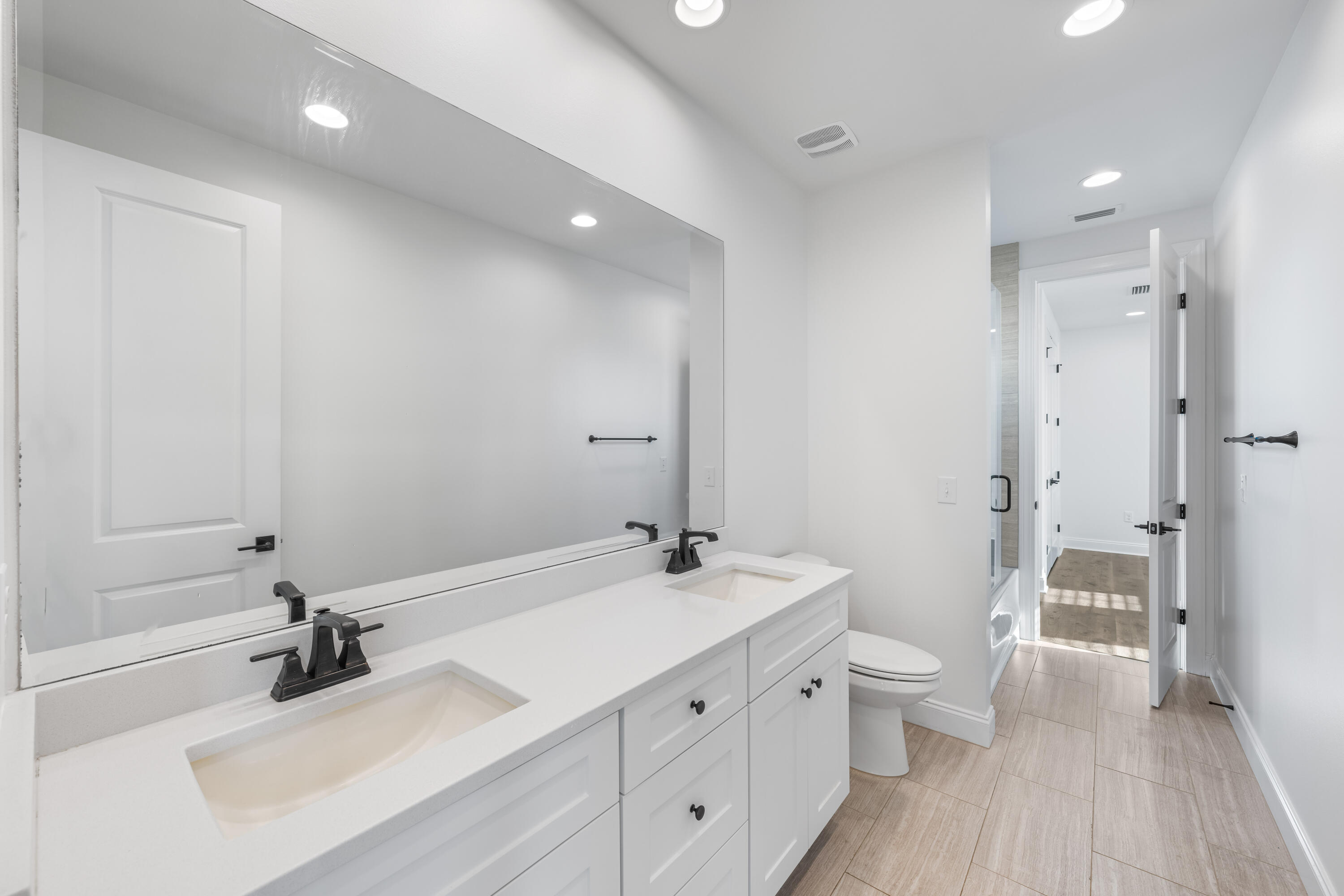 253 Windrow Way Watersound, FL 32461 - Photo 35 of 46 a bathroom with a double vanity sink a mirror and a toilet