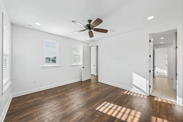 a view of empty room with wooden floor