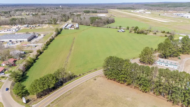 an aerial view of ocean and residential houses with outdoor space