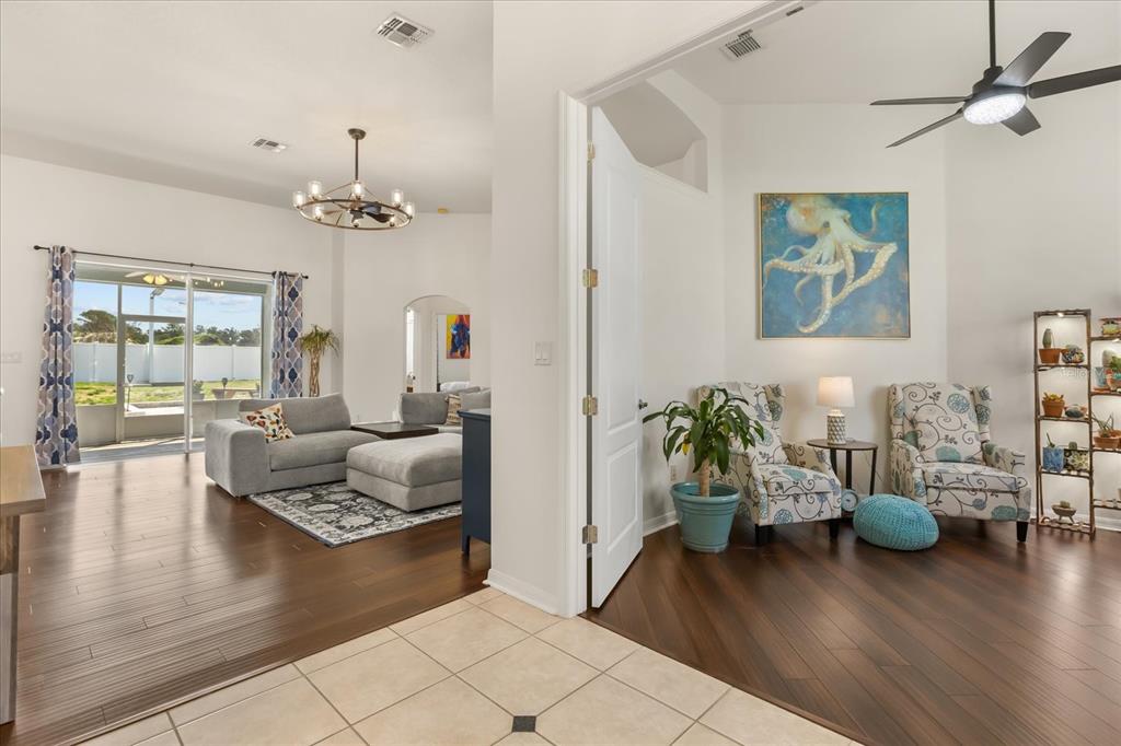 2309 Wolf Ridge Lane Mount Dora, FL 32757 - Photo 8 of 36 a living room with furniture and wooden floor