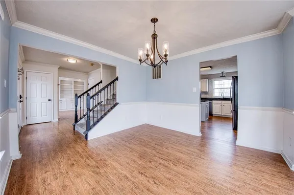 a view of a hallway view with wooden floor and staircase