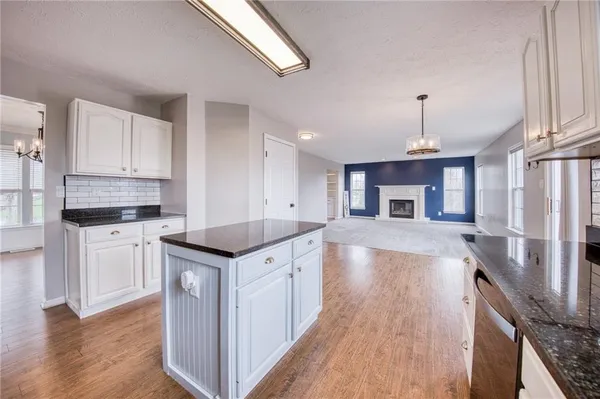 a kitchen with stainless steel appliances granite countertop a stove and a refrigerator