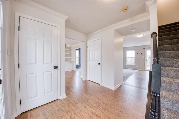 a view of a hallway with wooden floor