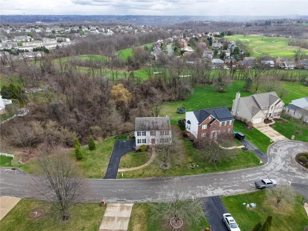 an aerial view of a house with garden space and ocean view