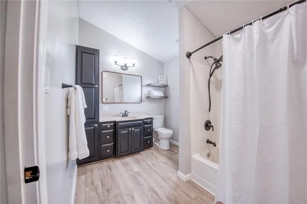 a kitchen with stainless steel appliances a refrigerator sink and wooden floor
