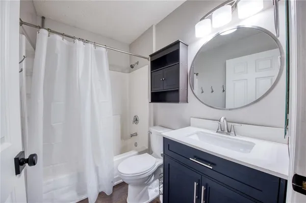 a bathroom with a sink vanity granite and a mirror