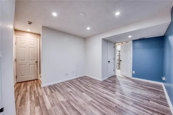 a view of empty room with wooden floor