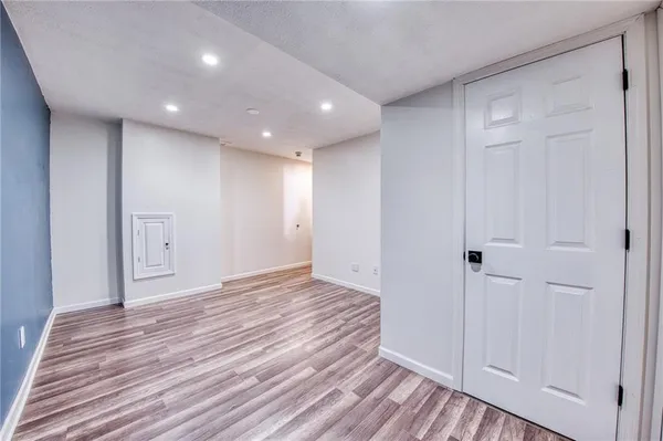a view of a hallway with wooden floor