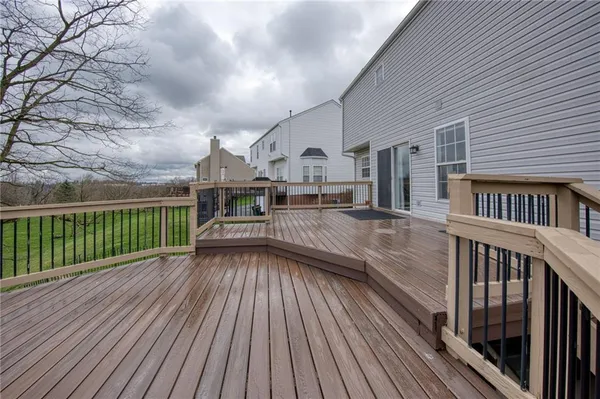 a view of a house with wooden deck
