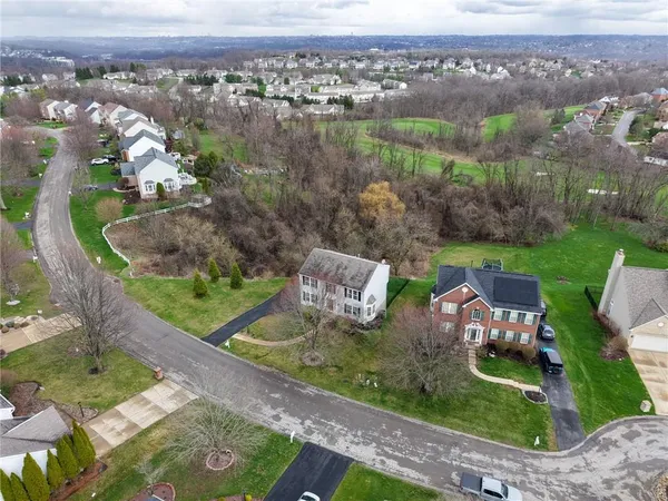 an aerial view of a house with yard
