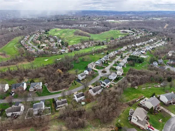 an aerial view of a house with a yard and lake view