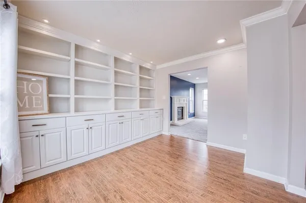a view of an empty room with a kitchen