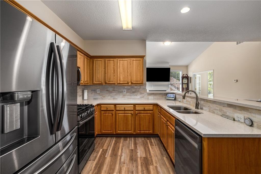 855 Camry Circle Dallas, GA 30157 - Photo 12 of 41 a kitchen with stainless steel appliances granite countertop a sink stove microwave and refrigerator