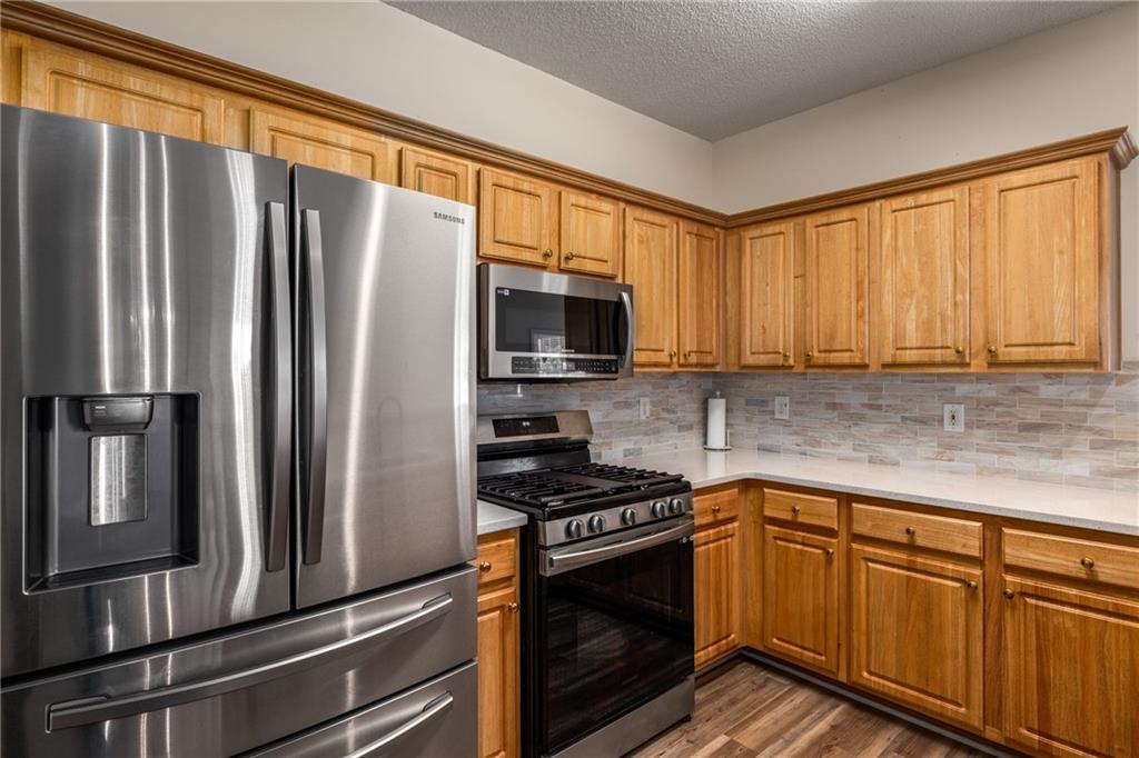 855 Camry Circle Dallas, GA 30157 - Photo 13 of 41 a kitchen with granite countertop a refrigerator stove and microwave