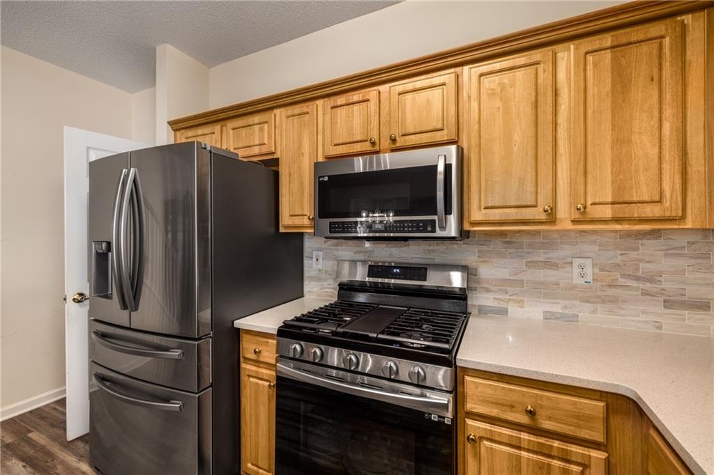 855 Camry Circle Dallas, GA 30157 - Photo 15 of 41 a kitchen with a refrigerator stove and microwave