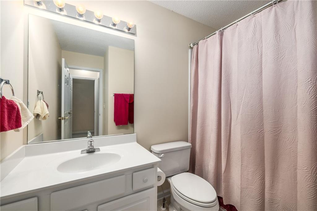855 Camry Circle Dallas, GA 30157 - Photo 27 of 41 a bathroom with a sink vanity mirror and toilet
