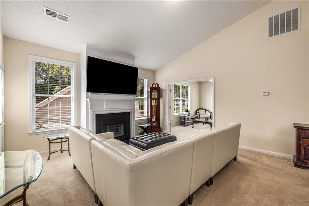 855 Camry Circle Dallas, GA 30157 - Photo 7 of 41 a living room with furniture a fireplace and a flat screen tv