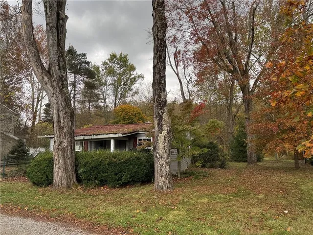 a view of house with yard and outdoor space