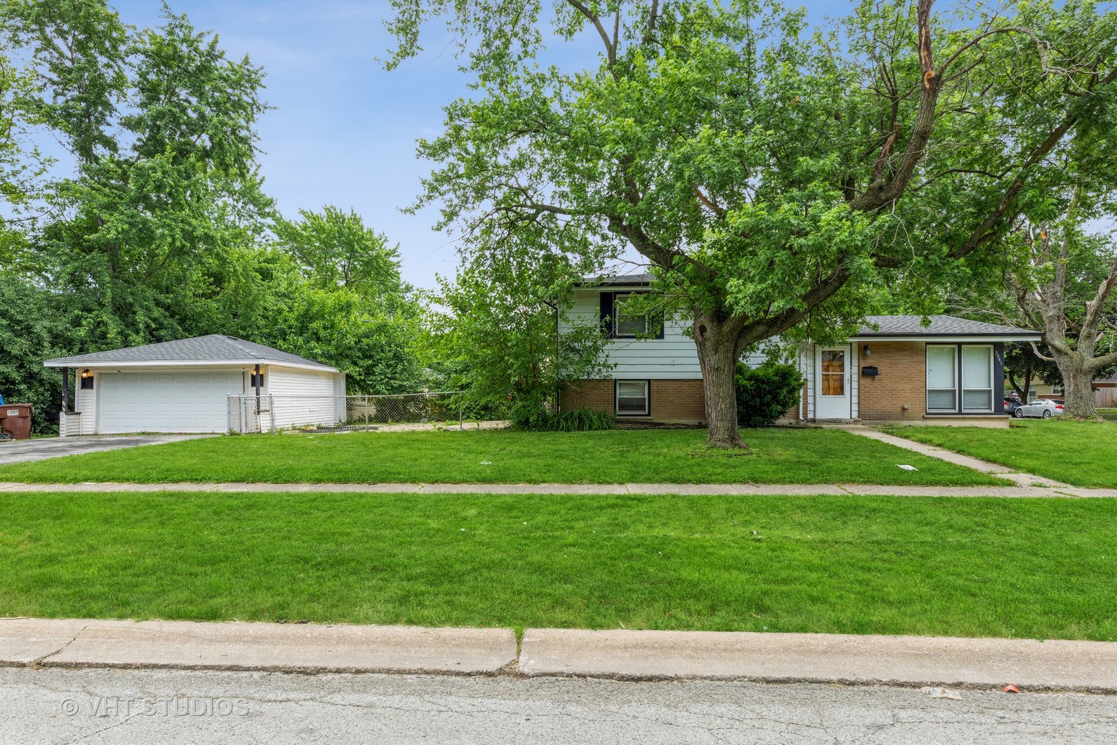 3941 169th Street Country Club Hills, IL 60478 - Photo 1 of 22 a front view of a house with a yard and trees