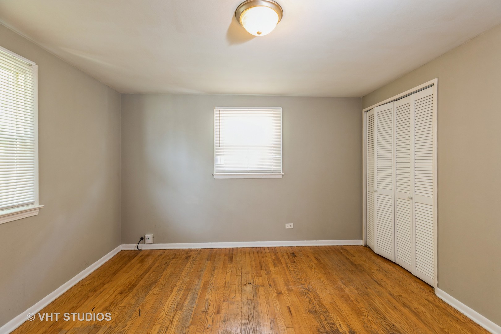 3941 169th Street Country Club Hills, IL 60478 - Photo 14 of 22 an empty room with wooden floor and windows