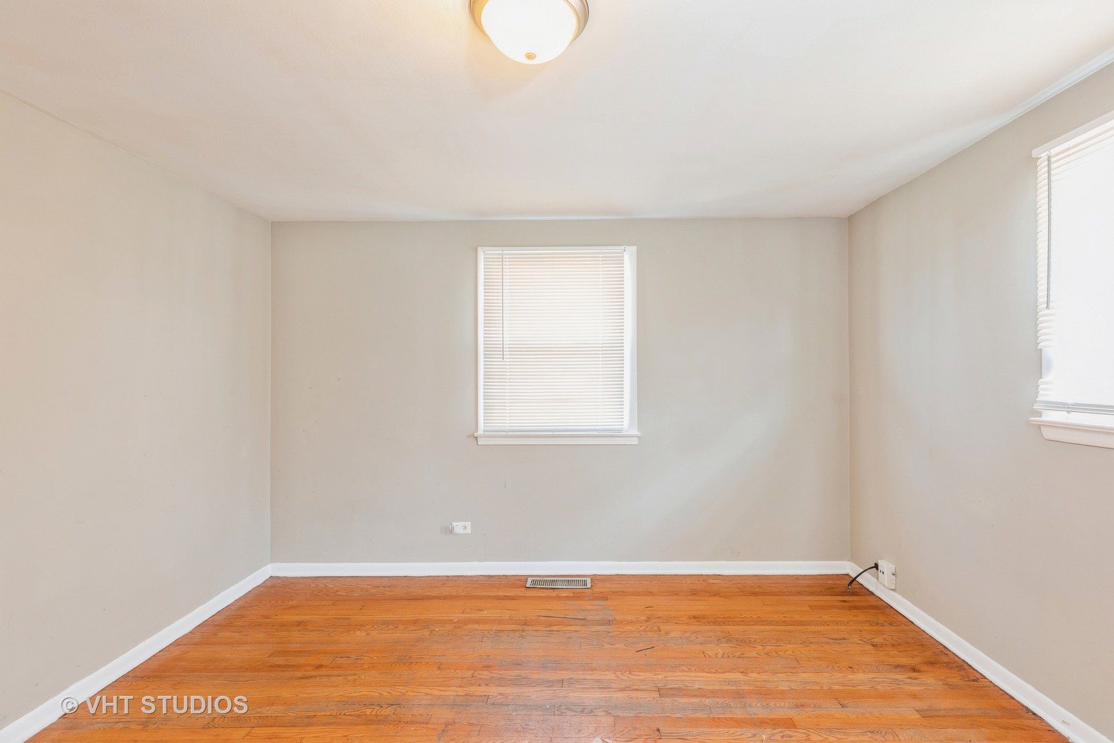 3941 169th Street Country Club Hills, IL 60478 - Photo 16 of 22 a view of an empty room with wooden floor and a window