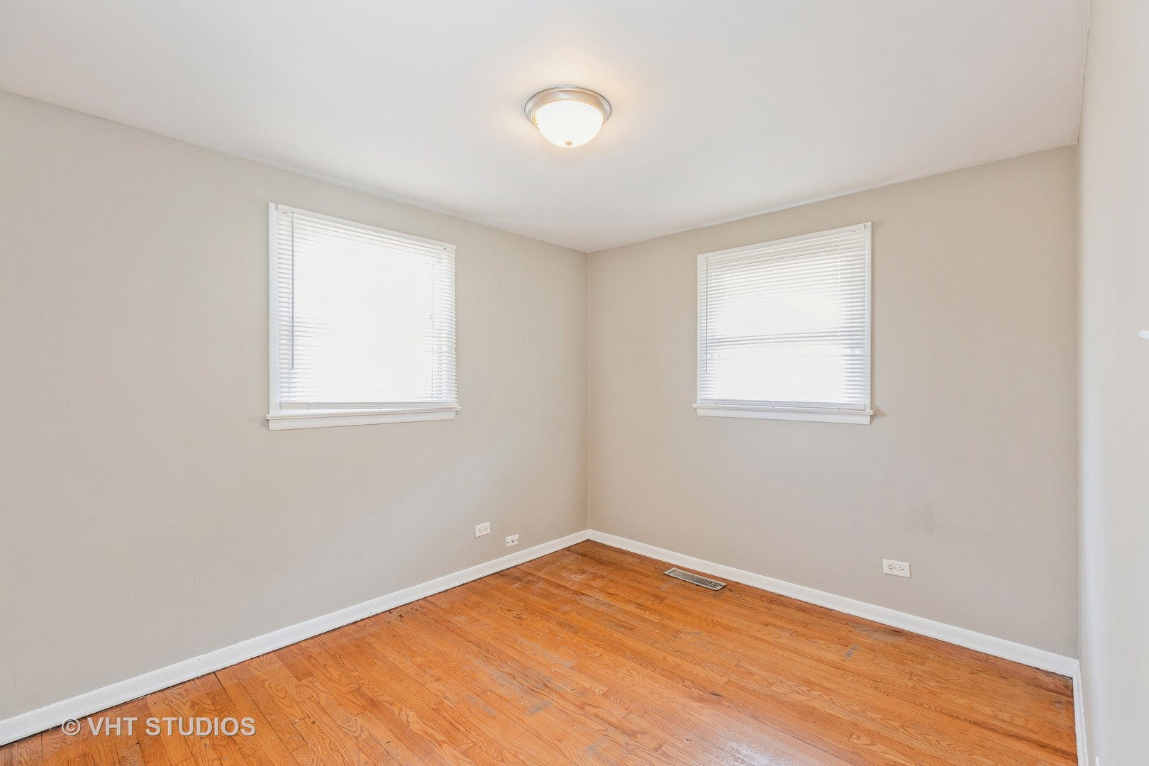 3941 169th Street Country Club Hills, IL 60478 - Photo 18 of 22 an empty room with wooden floor and windows