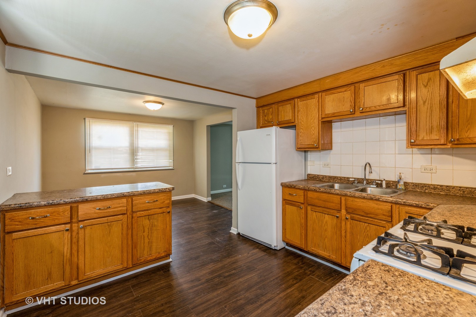 3941 169th Street Country Club Hills, IL 60478 - Photo 9 of 22 a kitchen with stainless steel appliances granite countertop a stove a sink dishwasher and a refrigerator with wooden floor