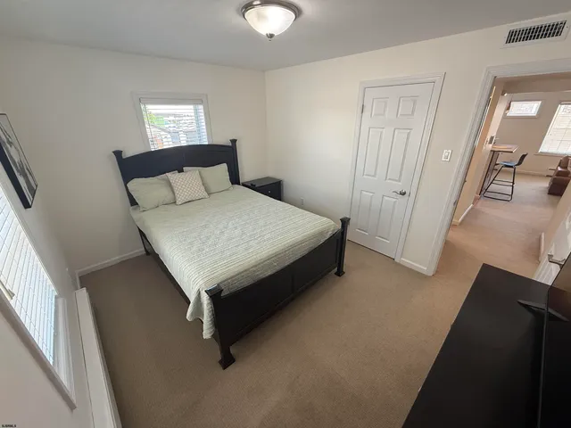 a bed sitting in a bedroom next to a window