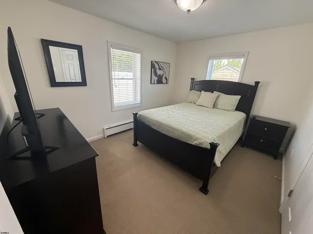 a spacious bedroom with a bed and window