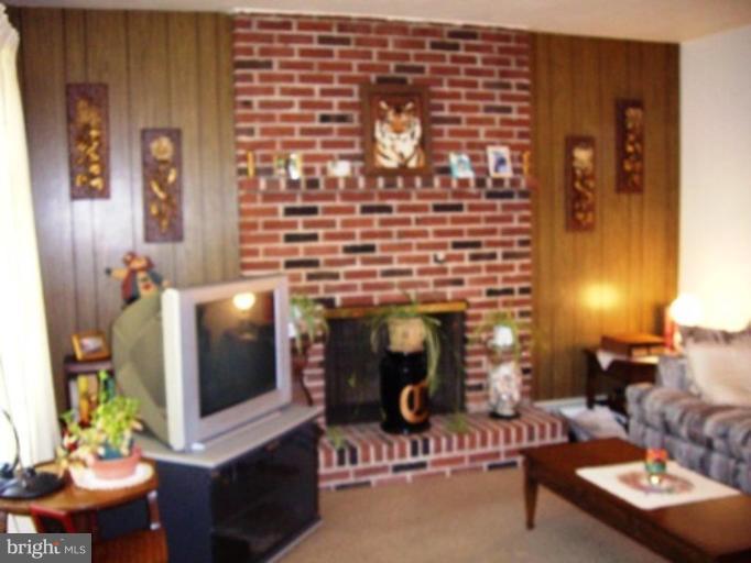 1317 Murgatroyd Road Fallston, MD 21047 - Photo 13 of 17 a living room with furniture and a fireplace