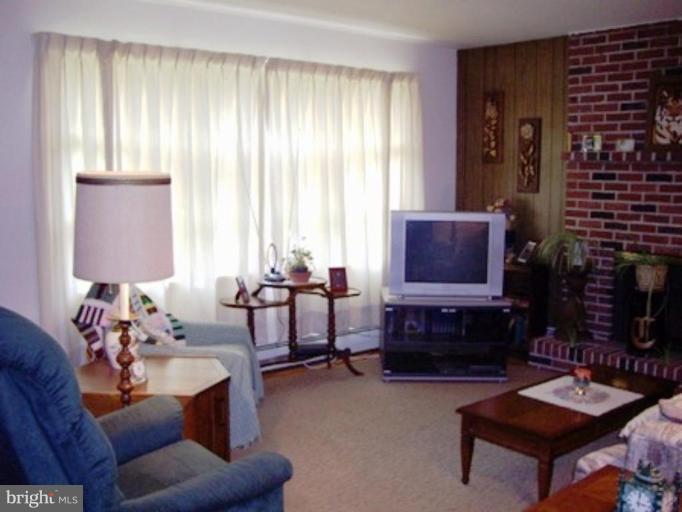 1317 Murgatroyd Road Fallston, MD 21047 - Photo 14 of 17 a living room with furniture a window and a fireplace